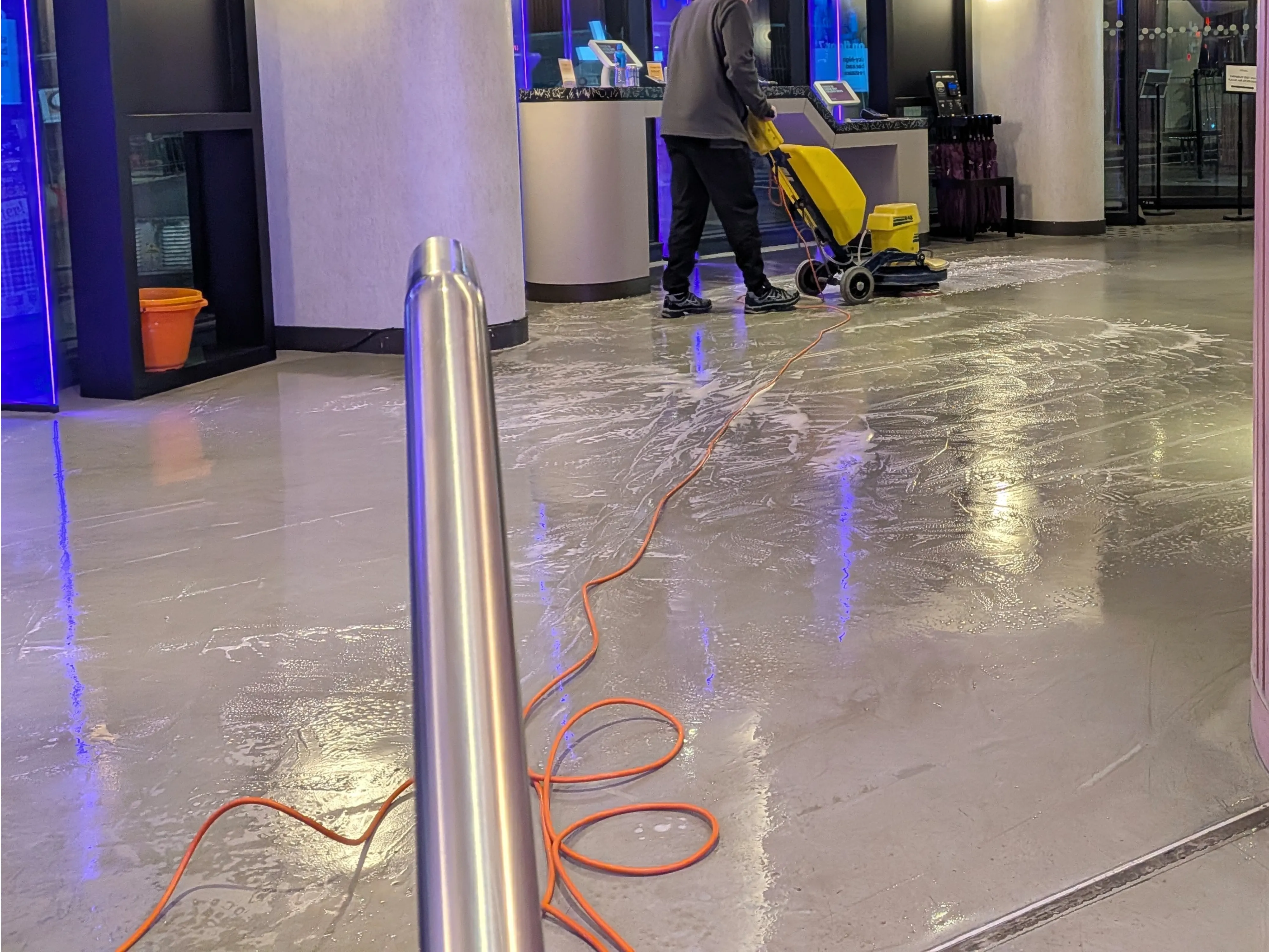 Heavy-duty diamond polishing machine restoring a Terrazzo floor in a Glasgow commercial space